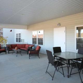 A spacious patio with comfortable seating and a dining area.
