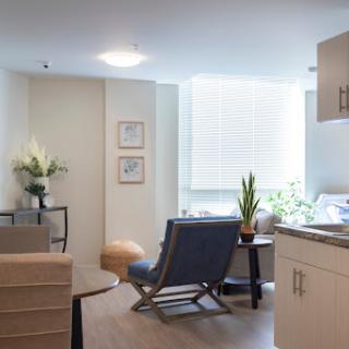 A bright and modern living space featuring comfortable furniture and indoor plants.