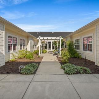 A view of a building's exterior with a landscaped pathway leading to the entrance.