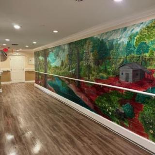 A vibrant mural depicting a serene natural landscape, adding color and life to the interior space.