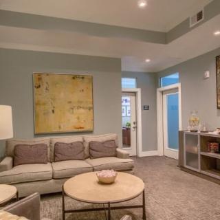 A modern living room featuring a comfortable sofa, stylish coffee table, and contemporary artwork.