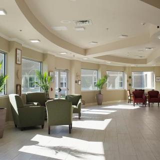 A sunlit lobby area with comfortable seating and large windows.