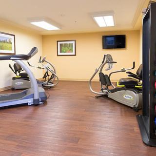 An indoor gym with various exercise equipment including treadmills and stationary bikes.