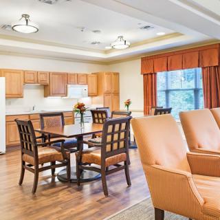 A spacious kitchen and dining area with wooden cabinets and comfortable seating.