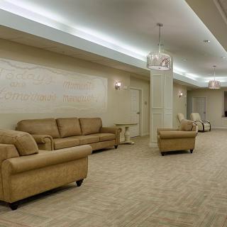 A spacious lobby with comfortable sofas and chairs, decorated in neutral tones.