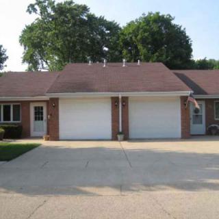 A suburban duplex with attached garages and a shared driveway.