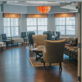 A cozy lounge area with comfortable seating and large windows.