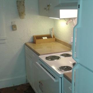 A small kitchen area with a stove and countertop.