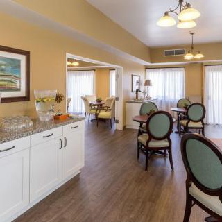 A well-lit dining area with neatly arranged tables and chairs.