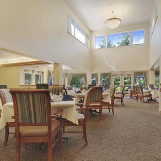 Spacious dining area with elegant seating and large windows.