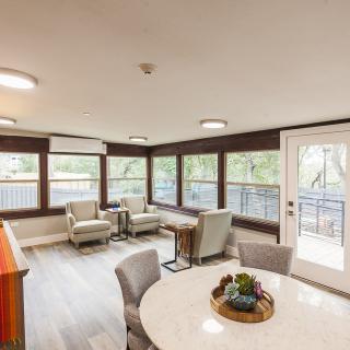 A bright and modern living room with large windows and comfortable seating.