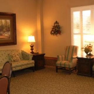 A cozy living room with sofas, an armchair, and warm lighting.