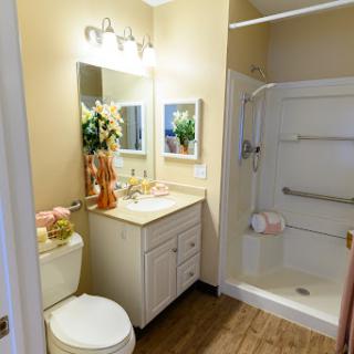 A well-lit modern bathroom featuring a stylish vanity and shower space.