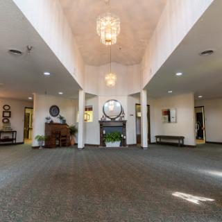 A spacious and elegantly designed lobby featuring modern lighting fixtures and tasteful decor.