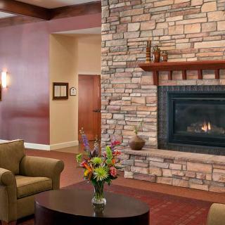 Cozy living room with a stone fireplace and comfortable seating.