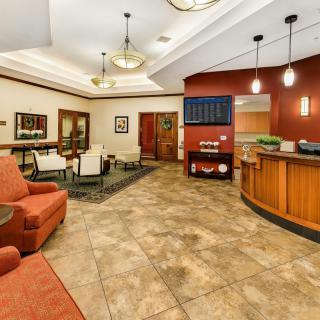 A cozy hotel lobby with comfortable seating and a reception desk.