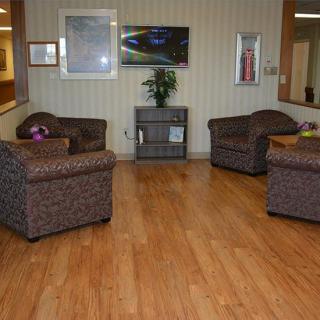 A cozy waiting area with comfortable chairs and artwork on the walls.