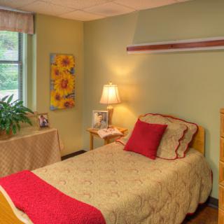 A cozy and inviting bedroom with a soft color palette and comfortable furnishings.