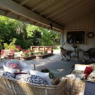 A cozy outdoor patio with comfortable seating and garden views.