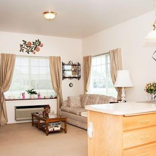 A cozy living room with a sofa, curtains, and decorative elements.