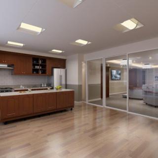 A modern kitchen featuring wooden cabinetry and an open layout with sliding glass doors.