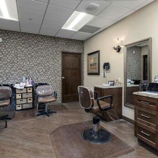 A modern hair salon featuring stylish barber chairs and elegant decor.