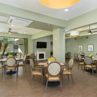 A modern dining area with neatly arranged tables and chairs, featuring a contemporary interior design.