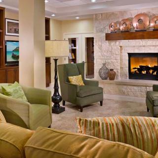 A cozy living room with a fireplace, comfortable seating, and stylish decor.