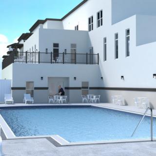 A sunny day by the swimming pool at a modern building's outdoor area.