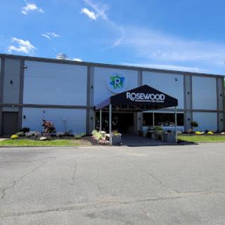 A retail establishment with a welcoming entrance under a canopy, set against a clear blue sky.