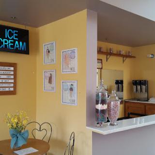 A cozy ice cream shop with a cheerful yellow interior.