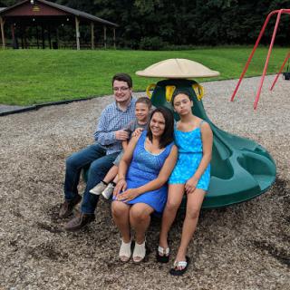A joyful family moment at the playground, enjoying a sunny day.