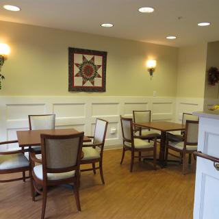 Cozy dining area with tables and chairs, adorned with wall decor.