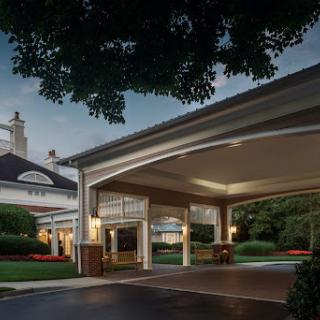 A welcoming entrance to a hotel during the evening, showcasing elegant architectural design.