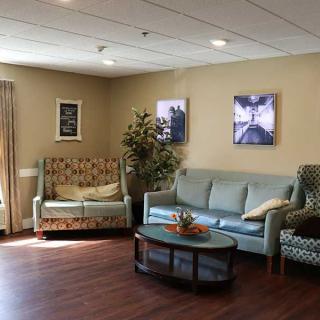 A cozy living room with sofas, a coffee table, and decorative artwork.