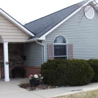 A suburban house with a front yard and driveway.