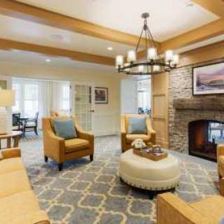 A cozy living room with comfortable seating and a warm fireplace.