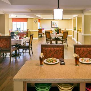 A spacious and well-lit dining area with multiple tables and chairs, creating a welcoming atmosphere.
