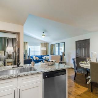 A modern open-concept kitchen and living room with stylish furniture and decor.