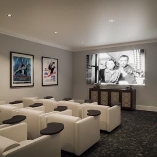 A luxurious home theater with comfortable seating, a large projector screen, and classic movie posters on the walls.