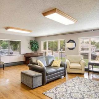 A spacious living room with modern furniture and ample natural light.