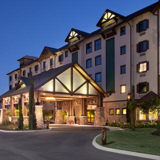 A well-lit hotel entrance at dusk, showcasing its inviting architecture.