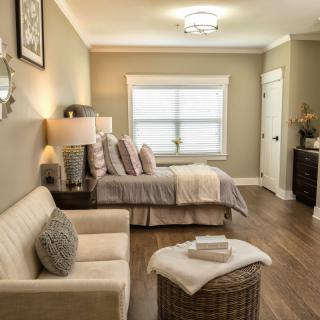 A cozy bedroom with neutral tones and elegant decor.