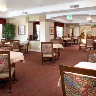 An elegant dining room with neatly arranged tables and chairs.