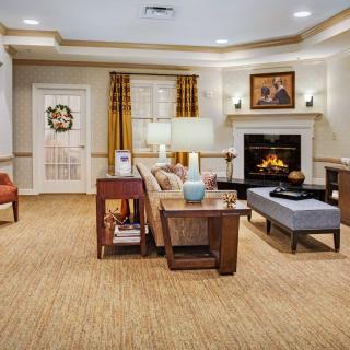 A cozy living room with a fireplace and comfortable seating.