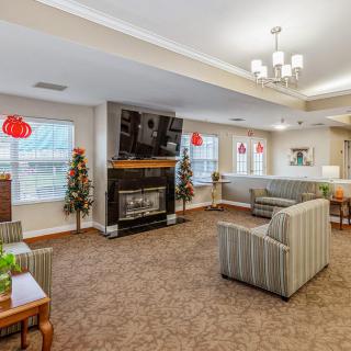 A cozy living room with a fireplace, television, and comfortable seating.
