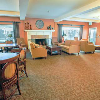 A cozy living room with a fireplace and comfortable seating.