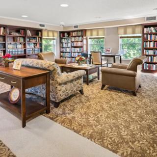 A cozy library space with comfortable seating and abundant natural light.