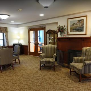 A cozy lounge area featuring striped armchairs and a welcoming atmosphere.