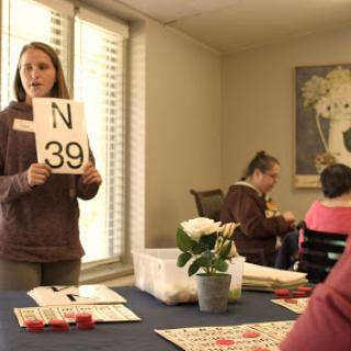 A community bingo game in progress, with a host calling out numbers.